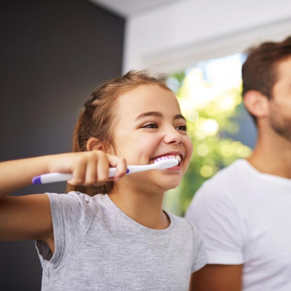 little girl brushing teeth